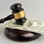 Caught on Video: Staffer Fakes Legal Credentials Gavel resting on hundred-dollar bills.