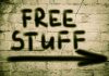 Internal WAR: Democrats’ Socialist Shift Graffiti on brick wall says free stuff arrow