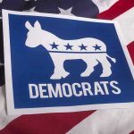 Democrat Civil War Erupts Over Shocking Accusation Democrats logo on American flag background