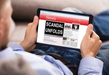 Non-Citizen Mayor EXPOSED—Election SCANDAL Ignites Person reading tablet with headline Scandal Unfolds.