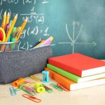 UN Power Grab Targets American Parents A collection of school supplies including notebooks, a pencil case, and writing instruments on a desk