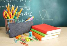 UN Power Grab Targets American Parents A collection of school supplies including notebooks, a pencil case, and writing instruments on a desk