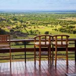Kentucky Horror: Man Thrown Off Balcony Outdoor seating area with wooden bar stools overlooking a green landscape