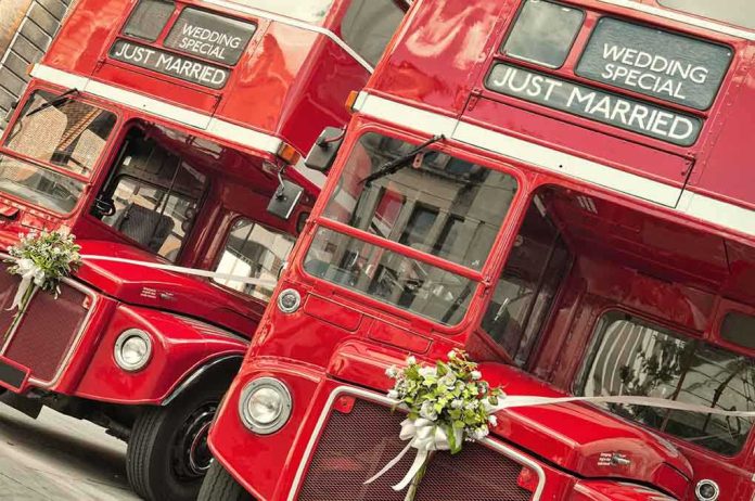 shutterstock_60366649.jpg Two red double-decker buses decorated for a wedding with Just Married signs