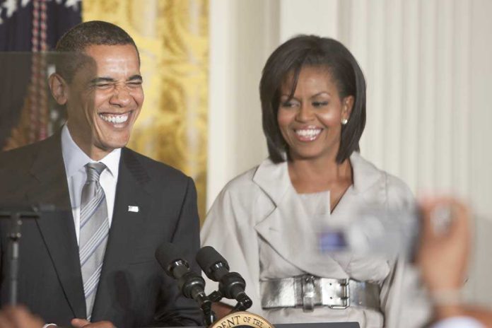 shutterstock_62048311.jpg Former President Barack Obama and Michelle Obama smiling at a public event
