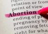 Florida Abortion Refusal Ends In Death Row Shocker Abortion highlighted in a dictionary with a pink marker.