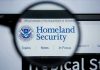 20-State Uprising Against DHS Sparks Controversy Magnifying glass showing Homeland Security website.