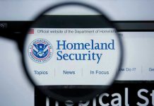 20-State Uprising Against DHS Sparks Controversy Magnifying glass showing Homeland Security website.