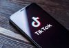 Illegal Immigrant Taunts U.S. Enforcement on TikTok Phone screen showing TikTok logo and app.