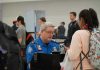 TSA Procedures Questioned After Pregnant Woman Encounter TSA agent checks passengers documents at airport security.