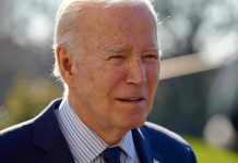 Russia Peace Talks EXPOSE Biden Disaster Elderly man in suit outside in daylight.