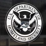 TSA Has a Surprisingly New Enforcement Role U.S. Department of Homeland Security emblem on wall.