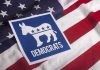 Wealthy Liberals Are Abandoning Democratic Party Democratic Party symbol on American flag background.