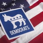 Wealthy Liberals Are Abandoning Democratic Party Democratic Party symbol on American flag background.