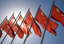 China’s TERRIFYING Digital Police State Goes Live Red flags with yellow stars on flagpoles.