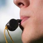 Referee’s Outrageous Act – Texas UIL Under Fire! Person holding a whistle in their mouth.