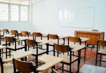 Another School Ignored Warning Signs Empty classroom with desks, chairs, and whiteboard.