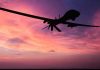 Drones Penetrate Nuclear Base — Nobody Stopped Them Silhouette of a drone against a colorful sunset.