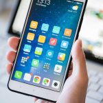 Netflix Mega-Grab Puts One Gatekeeper Over Culture A person holding a smartphone displaying various mobile applications