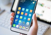 Netflix Mega-Grab Puts One Gatekeeper Over Culture A person holding a smartphone displaying various mobile applications