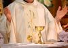 Freemasonry CONDEMNED by Catholic Church A priest holding a golden chalice during a religious ceremony