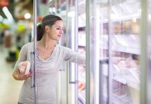 Florida Freezer Hoax EXPOSED—Truth Finally Revealed A woman shopping in the frozen food aisle of a supermarket