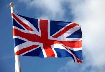 UK Now DEMANDING Discloser Of Private Associations British flag waving against a blue sky