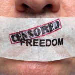 Netflix-Warner Deal Hides Obama Power Play Close-up of a persons mouth covered with tape that reads CENSORED FREEDOM