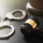 15-Year-Old’s Execution Plan Stuns America Handcuffs and judges gavel on the table.