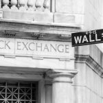 Trump Warren Pact Sends Wall Street Into Panic Stock Exchange building and Wall Street sign.