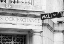Trump Warren Pact Sends Wall Street Into Panic Stock Exchange building and Wall Street sign.