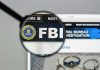 Trump’s FBI Pick Officially QUITS FBI website shown through magnifying glass.