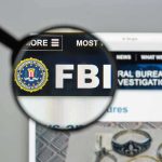 Trump’s FBI Pick Officially QUITS FBI website shown through magnifying glass.