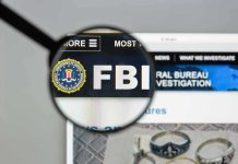 Trump’s FBI Pick Officially QUITS FBI website shown through magnifying glass.