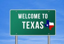 Wake Up Call ISSUED On Texas Welcome to Texas road sign with a Texas map