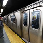 Segregation Demand ERUPTS On LA Subway Man waiting at subway platform with departing train.