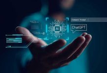 Office Jobs Hit First: AI Shock Hand holding digital AI and ChatGPT graphics.