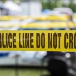 Murder Charge Against Dad Shocks Georgia Yellow police line tape with Do Not Cross.