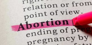 SHOCKING Campus Program TRAINS Teens as Abortion Activists Abortion highlighted in a dictionary with a pink marker.