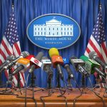 Was Musk, Zuckerberg Linked to Trump’s AI U-Turn? Multiple microphones at White House press briefing podium.