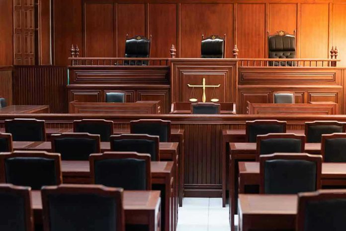 1324425602 Empty courtroom with wooden furniture and black chairs.
