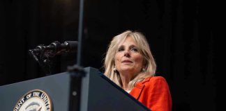 Jill Biden’s Stroke Admission SHATTERS Campaign Narrative Person speaking at podium with Vice President seal.