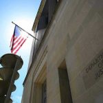 Trump Suits Up: $1.7 Billion ‘War Chest’ Shocker American flag at Department of Justice building exterior.