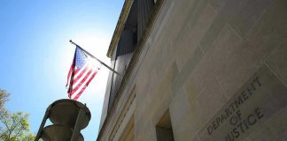 Trump Suits Up: $1.7 Billion ‘War Chest’ Shocker American flag at Department of Justice building exterior.