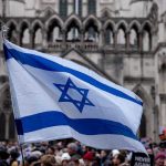 Tradition Shattered: NYC Mayor Ghosts Israel Parade Israeli flag at a crowded outdoor event.