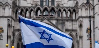 Tradition Shattered: NYC Mayor Ghosts Israel Parade Israeli flag at a crowded outdoor event.