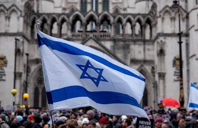 2393485591 Israeli flag at a crowded outdoor event.
