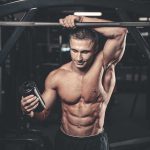Youth’s Secret Peptide Injections: Shocking Risks Unveiled Muscular man in gym holding a shaker bottle