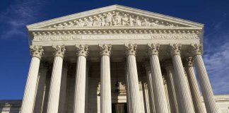 Supreme Court Showdown: Gerrymandering Drama Unfolds Facade of the Supreme Court building featuring tall columns and intricate carvings