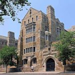 AOC’s Bold Claim Sparks Revolutionary Debate Historic university building with stone facade and surrounding trees